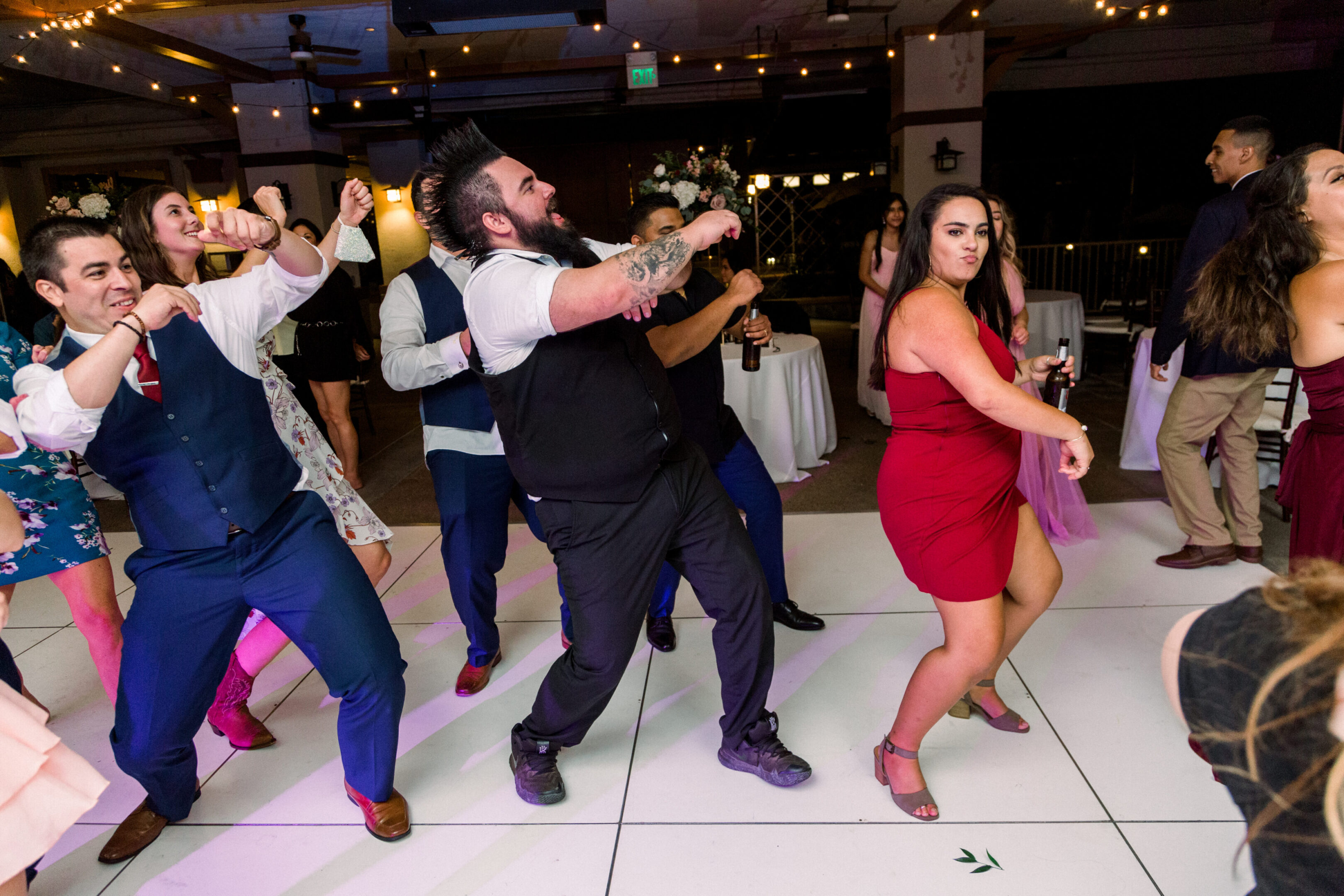 People dancing energetically at a festive indoor event.